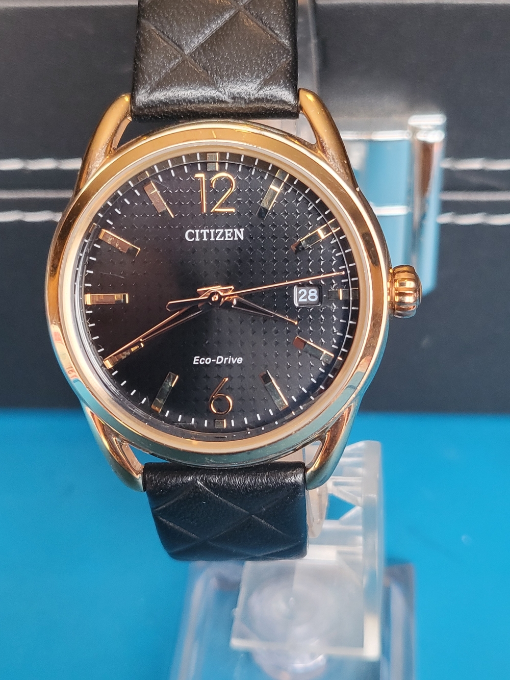 Citizen Eco-Drive Rose Gold Tone Black Dial Leather Strap Watch. Unisex